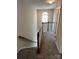 Upstairs hallway with carpet, chandelier, and staircase at 3617 Betterton Ln, Charlotte, NC 28269