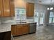 Well-equipped kitchen features granite countertops, a stainless steel sink, and modern appliances at 3617 Betterton Ln, Charlotte, NC 28269