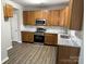 Updated kitchen with stainless steel appliances, granite countertops, and wooden cabinetry at 3617 Betterton Ln, Charlotte, NC 28269