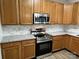 Modern kitchen featuring stainless steel appliances, granite countertops, and stylish wooden cabinetry at 3617 Betterton Ln, Charlotte, NC 28269