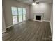 Bright living room with a fireplace, tall ceilings and a large window that offers lots of light at 3617 Betterton Ln, Charlotte, NC 28269