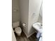 Well-lit powder room featuring a pedestal sink, toilet, and neutral decor at 3617 Betterton Ln, Charlotte, NC 28269