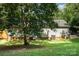 Lush backyard with mature trees shading the home, a shed, and neatly kept grass at 394 Link Dr, Iron Station, NC 28080