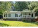 Charming single-Gathering home with a cozy front porch and well-maintained lawn at 394 Link Dr, Iron Station, NC 28080