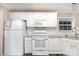 Bright kitchen featuring white appliances, cabinetry, and subway tile backsplash at 394 Link Dr, Iron Station, NC 28080
