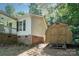 Exterior view of a house and a wooden shed, showcasing the outdoor features of the property at 394 Link Dr, Iron Station, NC 28080