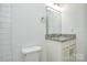 Bright bathroom featuring white cabinets, granite vanity, and ample lighting at 402 Gibson Park Dr, Huntersville, NC 28078
