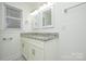 Bathroom vanity with double sinks, granite countertops, and modern fixtures at 402 Gibson Park Dr, Huntersville, NC 28078
