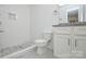 Well-lit bathroom featuring a granite vanity top, white cabinets, and a tiled walk-in shower at 402 Gibson Park Dr, Huntersville, NC 28078