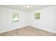 Bedroom featuring wood-look floors and natural light from two windows at 402 Gibson Park Dr, Huntersville, NC 28078