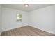 Bright bedroom with wood-look floors and a window providing natural light at 402 Gibson Park Dr, Huntersville, NC 28078