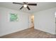 Bright bedroom featuring wood-look floors, a ceiling fan, and a window at 402 Gibson Park Dr, Huntersville, NC 28078
