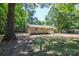 Lovely one-story brick home, surrounded by mature trees, and landscaped for attractive curb appeal at 402 Gibson Park Dr, Huntersville, NC 28078