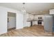 Open kitchen with stainless steel appliances, granite countertops, modern lighting, and new floors at 402 Gibson Park Dr, Huntersville, NC 28078