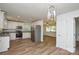 Newly remodeled kitchen with stainless steel appliances, granite countertops, modern lighting, and new floors at 402 Gibson Park Dr, Huntersville, NC 28078