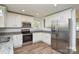 Well-lit kitchen features granite countertops, stainless steel appliances, and white cabinetry at 402 Gibson Park Dr, Huntersville, NC 28078
