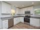 Bright kitchen featuring granite countertops, stainless steel appliances, and modern cabinets at 402 Gibson Park Dr, Huntersville, NC 28078