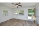 Bright living room with fresh paint and natural light, featuring new flooring and ceiling fan at 402 Gibson Park Dr, Huntersville, NC 28078