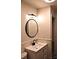 Bathroom featuring a vanity, modern lighting, and a round mirror at 412 E Taylor St, Landis, NC 28088