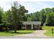 Charming one-story brick home with a manicured lawn and mature tree at 412 E Taylor St, Landis, NC 28088