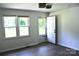 Bright room with light wood-look floors, two windows, and an exterior door at 412 E Taylor St, Landis, NC 28088