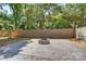 Backyard featuring a stone fire pit area surrounded by mature trees and landscaping at 4226 Raney Way, Charlotte, NC 28205