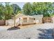 Exterior view of the home showcasing the back deck and a gravel driveway at 4226 Raney Way, Charlotte, NC 28205