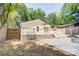 Home's backyard featuring a deck, fire pit, and privacy fence at 4226 Raney Way, Charlotte, NC 28205