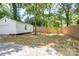 Fenced backyard featuring a detached garage with concrete patio at 4226 Raney Way, Charlotte, NC 28205