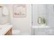 Modern bathroom featuring a glass-enclosed shower, white tile, and sleek fixtures at 4226 Raney Way, Charlotte, NC 28205