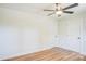 A bright bedroom with new light hardwood floors, two large closet doors and a ceiling fan at 4226 Raney Way, Charlotte, NC 28205