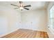A bright bedroom with new light hardwood floors, two large closet doors and a ceiling fan at 4226 Raney Way, Charlotte, NC 28205