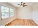 A bright bedroom with new light hardwood floors, and a large window at 4226 Raney Way, Charlotte, NC 28205