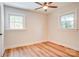Bright, simple bedroom with hardwood floors and two windows letting in ample natural light at 4226 Raney Way, Charlotte, NC 28205