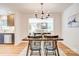 Open concept dining room with modern chandelier and views into living area at 4226 Raney Way, Charlotte, NC 28205