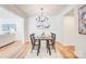 Bright dining room featuring a chandelier and wood-look flooring, perfect for entertaining guests at 4226 Raney Way, Charlotte, NC 28205