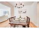 Dining room with modern light fixture, wainscotting, and hard wood floors at 4226 Raney Way, Charlotte, NC 28205