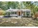 Charming single-story home featuring a white brick facade, dark shutters, and a well-manicured front yard at 4226 Raney Way, Charlotte, NC 28205