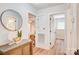 Hallway with a round mirror, modern decor and open doorways to other rooms at 4226 Raney Way, Charlotte, NC 28205