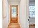 Bright hallway with a wood door, light walls, and wood floors at 4226 Raney Way, Charlotte, NC 28205