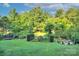 Expansive backyard featuring a trampoline, swing set, fire pit, and seating area at 4831 Antioch Church Rd, Matthews, NC 28104