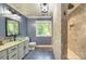 Bathroom features a modern glass sink, tiled shower, and a window providing natural light at 4831 Antioch Church Rd, Matthews, NC 28104