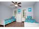 Bright bedroom with hardwood floors, ceiling fan, and matching twin beds with colorful bedding at 4831 Antioch Church Rd, Matthews, NC 28104