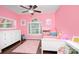 Bright bedroom features hardwood floors, a large window, and a colorful, playful decor at 4831 Antioch Church Rd, Matthews, NC 28104