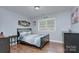 Cozy bedroom with hardwood floors, ample natural light, and a comfortable bed at 4831 Antioch Church Rd, Matthews, NC 28104