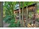View of the custom-built chicken coop, surrounded by lush greenery and trees at 4831 Antioch Church Rd, Matthews, NC 28104