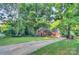 Beautiful brick home with a long driveway and well-manicured lawn on a sunny day at 4831 Antioch Church Rd, Matthews, NC 28104