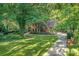 Gorgeous two-story brick home with lush green lawn and mature trees on a sunny day at 4831 Antioch Church Rd, Matthews, NC 28104