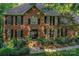 A brick home with classic shutters, a detailed front door and manicured landscaping at 4831 Antioch Church Rd, Matthews, NC 28104