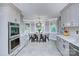 Bright eat-in kitchen boasts white cabinets, stainless steel appliances, and a cozy dining area at 4831 Antioch Church Rd, Matthews, NC 28104